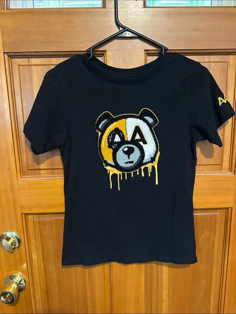 Black Women’s Graphic Tee with Yellow & White Bear Patch